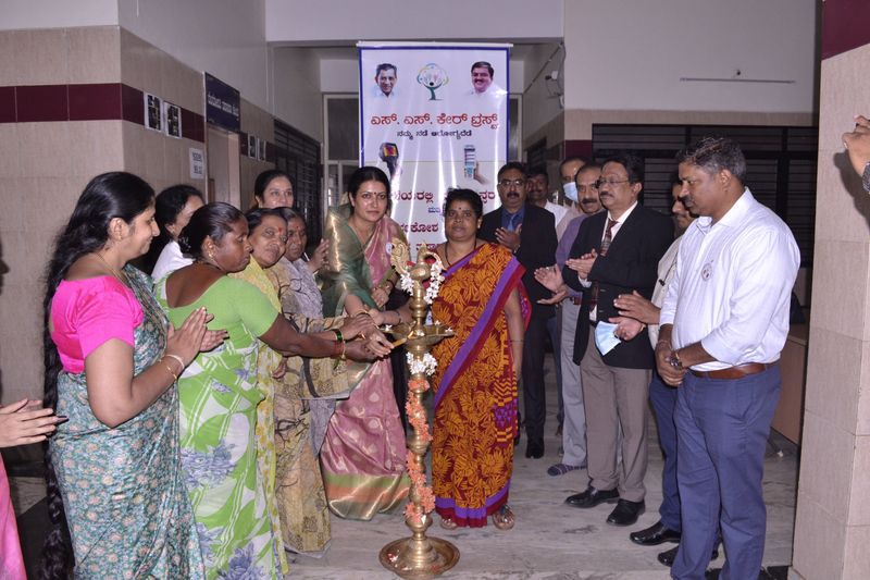 Women and doctors light a ceremonial lamp to open the Spandana breast screening centre.