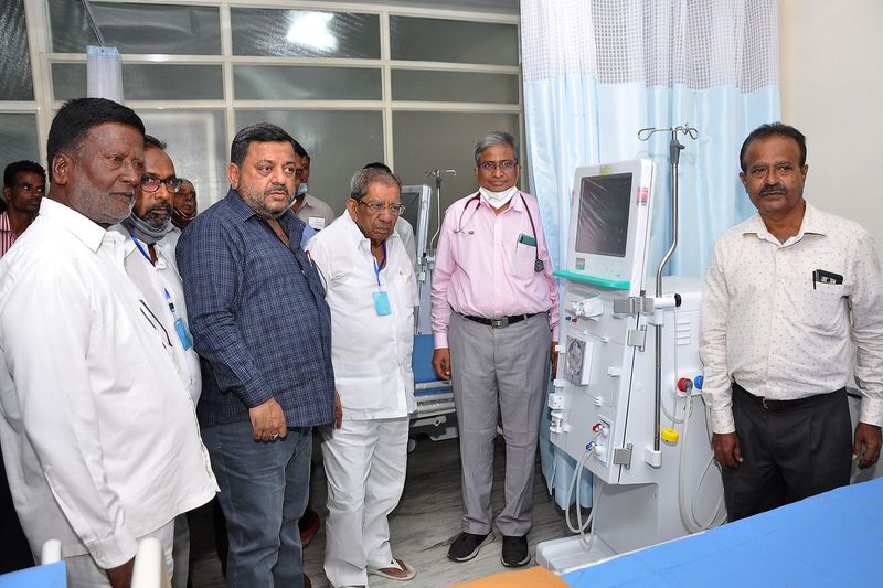 Trustees and doctors stand beside a new dialysis machine at the haemodialysis centre.