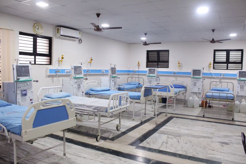 A row of hospital beds, each beside a dialysis machine, in the expanded dialysis centre.