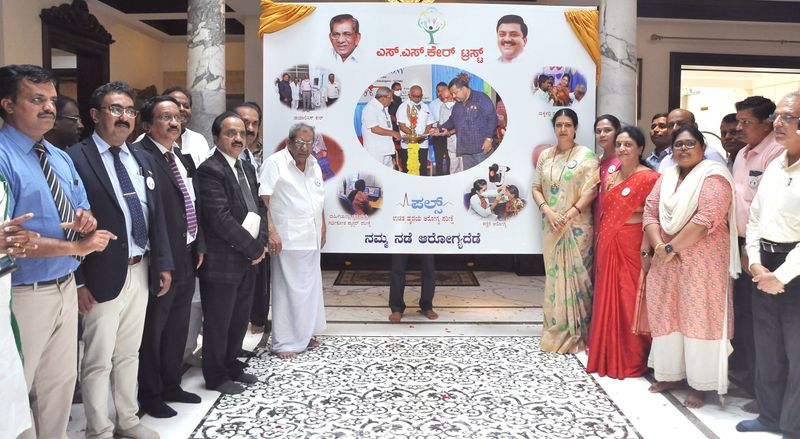 Doctors and trustees stand beside the banner at the launch of the PULSE tele-ECG camps.