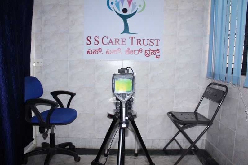 A screening room at SS General Hospital, with the SS Care Trust logo on the wall.