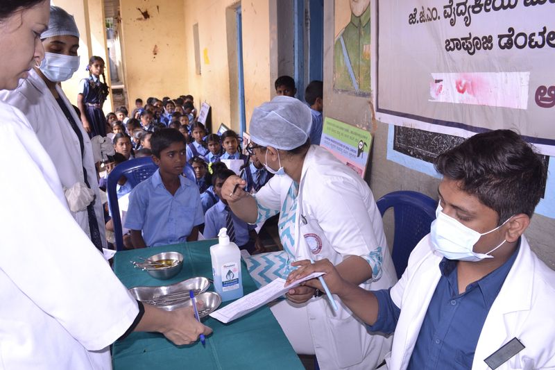 Dental students register schoolchildren at an oral health screening camp.