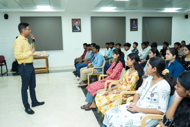 A facilitator speaks to a seated group of young trainees during a first aid and CPR awareness session.