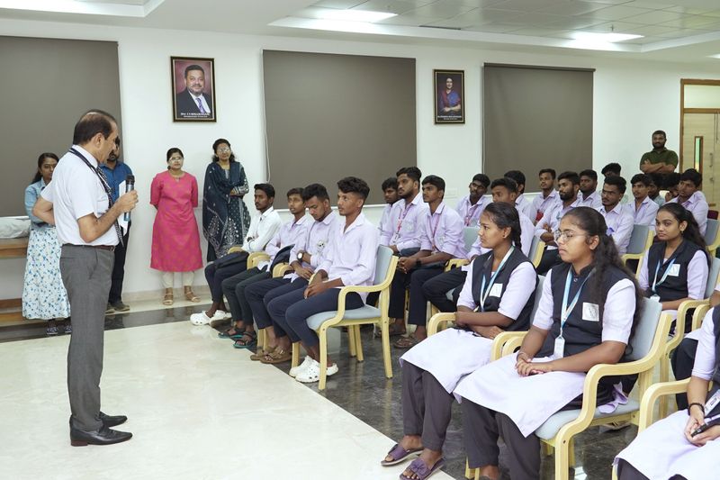 A trainer speaks to a seated group of uniformed students during a first aid awareness session.