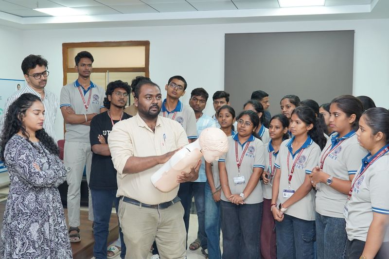 A student speaks into a microphone during an interactive question and answer segment of a first aid training session.