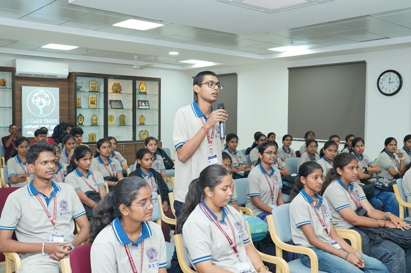 A large group of students and trainers pose together with completion certificates after a basic life support programme.