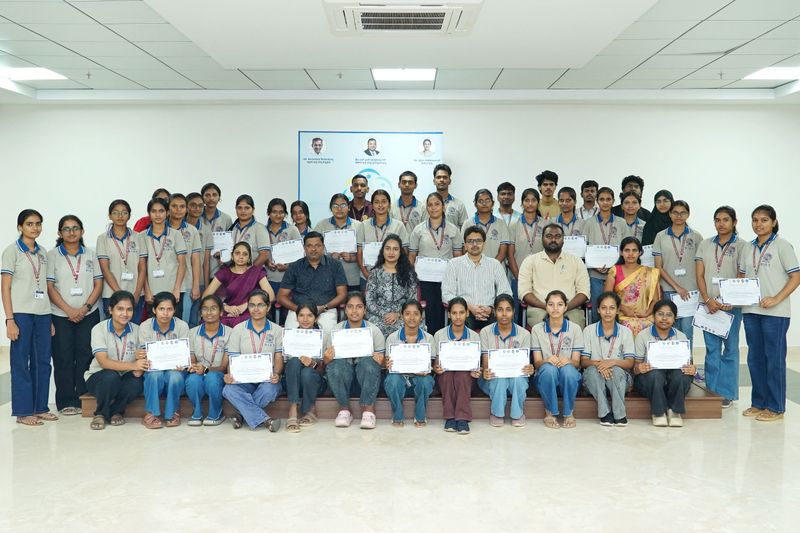 A mixed group of community health workers and trainers gather for a group photo after a basic life support training session.