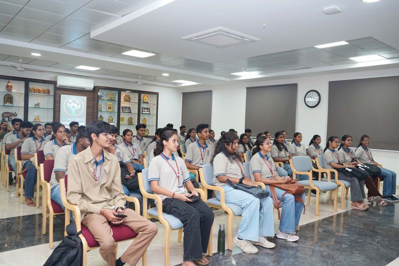 Seated participants listen attentively during a first aid and basic life support training session in a meeting hall.