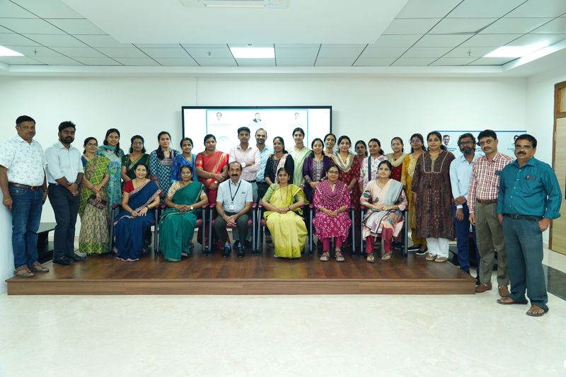 Large group photo of trainers and participants posed together after a first aid training programme.