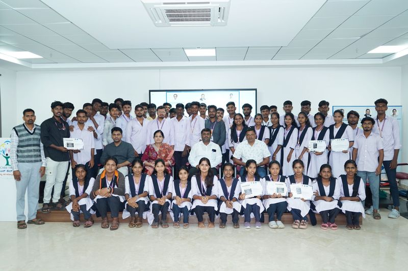 Group photo of trainees and staff holding certificates after completing a first aid training programme.