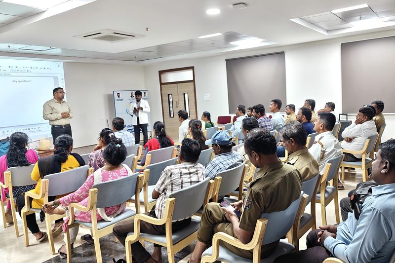 Audience including uniformed personnel seated in a hall during a first aid and emergency response training talk.