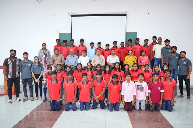 Large group of school students pose with programme staff and guests after a Kaushalya session.