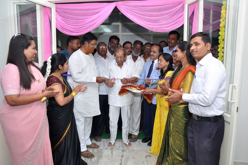 Dignitaries and guests cutting a ribbon at the entrance of SS Care Trust's dialysis centre during its inaugural ceremony.